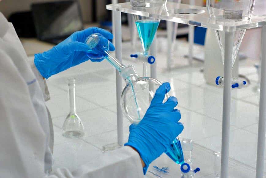 quimico ambiental sostiene matraz guantes azules